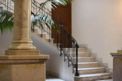 a set of stairs in a building with a column at The Tangerine's Garden in Palermo