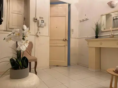 a living room with a vase with white flowers in it at The Tangerine's Garden in Palermo