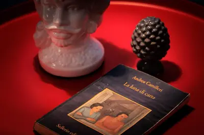 a book sitting on a table next to a statue at Merlo5 in Palermo