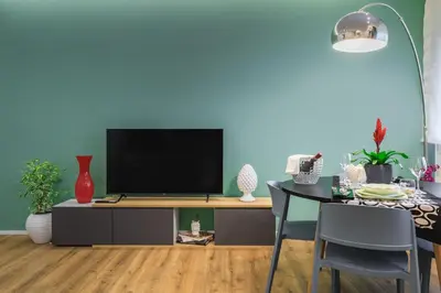 a living room with a tv on a entertainment center at Merlo5 in Palermo