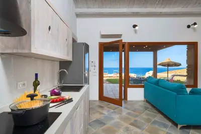 a kitchen with a view of the ocean at Villa Scopello Cala Bianca in Castellammare del Golfo