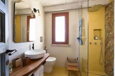 a bathroom with a toilet and a sink and a shower at Villa Scopello Cala Bianca in Castellammare del Golfo