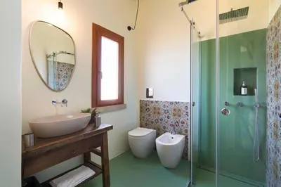 a bathroom with a sink and a toilet and a shower at Villa Scopello Cala Bianca in Castellammare del Golfo