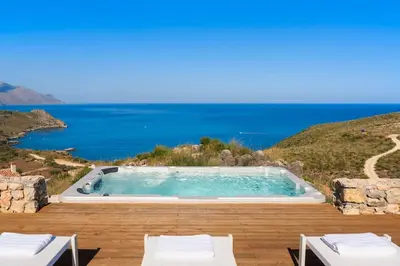 a swimming pool with a view of the ocean at Villa Scopello Cala Bianca in Castellammare del Golfo