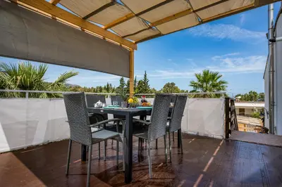 a patio with a table and chairs on a balcony at Trinacrys - Casa Vacanze in Alcamo