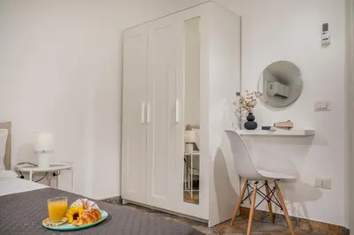a bedroom with a bed and a table with a plate of food at Trinacrys - Casa Vacanze in Alcamo