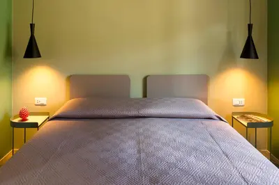 a bedroom with a large bed with two night stands at Villa Ancora Cala Bianca in Castellammare del Golfo