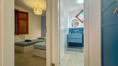 a room with two beds and a bathroom at Villa Sao Scopello Punta Pispisa in Scopello