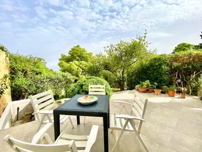a black table and chairs on a patio at Villa Sao Scopello Punta Pispisa in Scopello