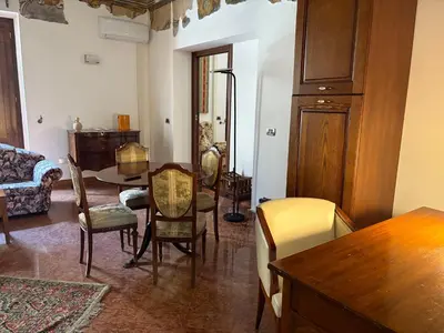 a living room with a table and chairs and a couch at Daniel's Winter in Palermo
