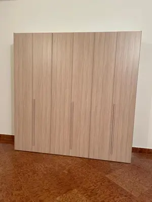 a wooden cabinet in the corner of a room at Daniel's Winter in Palermo