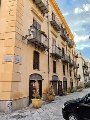 a building with balconies and potted plants on a street at Daniel's Winter in Palermo
