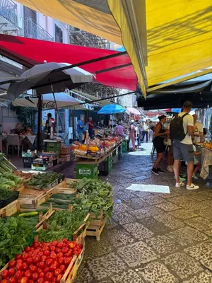 a market with a bunch of fruits and vegetables at Daniel's Winter in Palermo