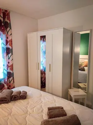 a bedroom with a large bed with towels on it at Casa Nicuzza alla Zisa in Palermo