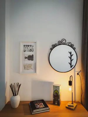 a mirror on a wall above a wooden desk at Casa Nicuzza alla Zisa in Palermo