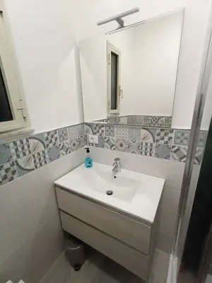 a bathroom with a sink and a mirror at Casa Nicuzza alla Zisa in Palermo