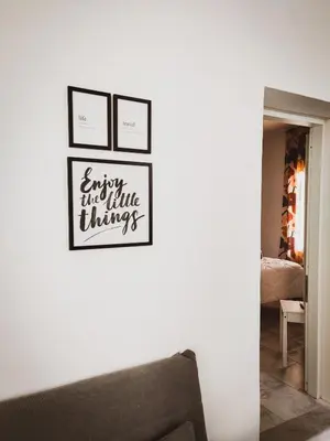 three framed pictures on a wall with a couch at Casa Nicuzza alla Zisa in Palermo