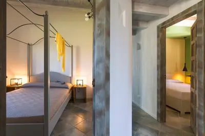 a bedroom with a canopy bed in a room at Villa Disa Cala Bianca in Castellammare del Golfo