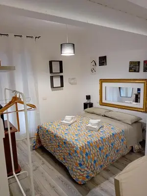 a bedroom with a bed and a mirror on the wall at Accademia in Palermo