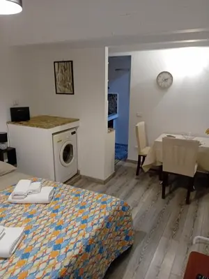 a room with a bed and a kitchen and a table at Accademia in Palermo
