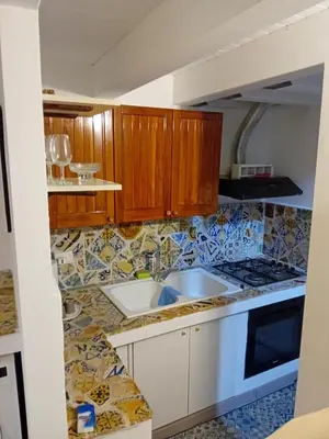 a kitchen with wooden cabinets and a sink at Accademia in Palermo