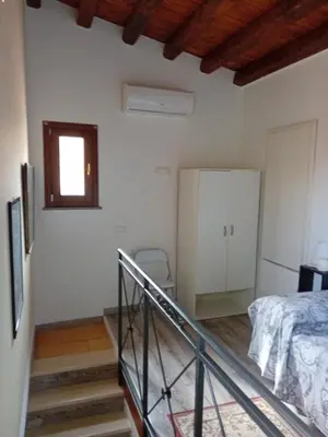 a white room with a bed and a window at Accademia in Palermo