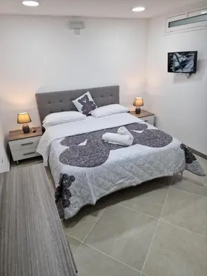 a bedroom with a large bed with two towels on it at Rosselli house 5 in Palermo