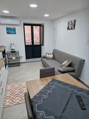 a living room with a couch and a table at Rosselli house 5 in Palermo