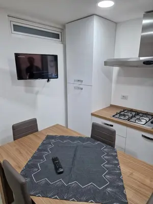 a kitchen with a table with a remote control on it at Rosselli house 5 in Palermo