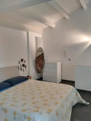 a bedroom with a large bed and a mirror at Loft in Vucciria in Palermo