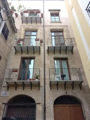 a building with balconies on the side of it at Loft in Vucciria in Palermo