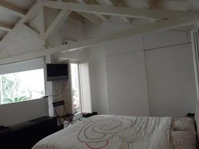 a bedroom with a bed and a flat screen tv at Loft in Vucciria in Palermo