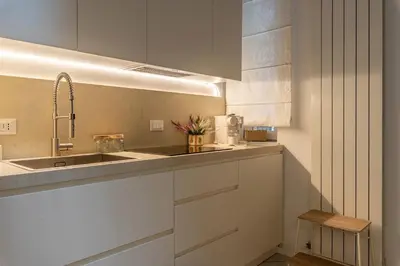 a kitchen with white cabinets and a sink at La casa nel baglio in Palermo