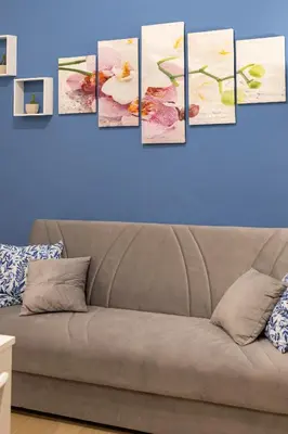 a modular picture of flowers on a blue wall at Giancos apartment in Palermo