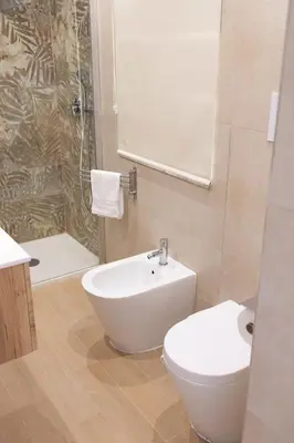 a bathroom with a toilet and a sink and a shower at Giancos apartment in Palermo
