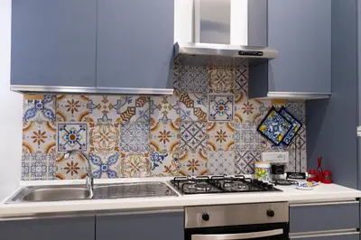 a kitchen with a sink and a stove top oven at Giancos apartment in Palermo