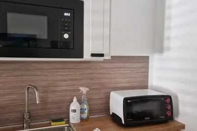 a kitchen counter with a toaster and a microwave at Casa Maielli in Palermo