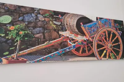 a wooden cart with a barrel on it next to a plant at Casa Maielli in Palermo