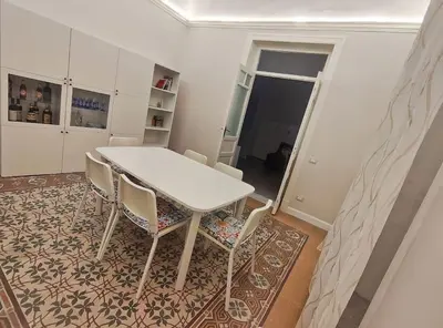 a dining room with a white table and chairs at L'ùoro Apartment in Carini