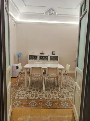 a dining room with a white table and chairs at L'ùoro Apartment in Carini