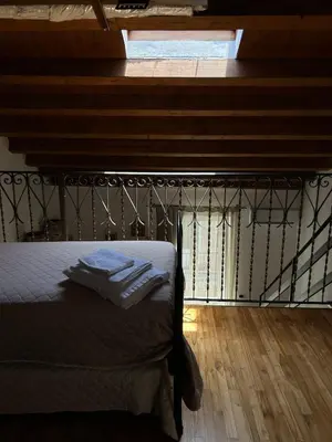 a bedroom with a bed with a window and a wooden floor at Appartamento Palermo Sole di Sicilia in Palermo