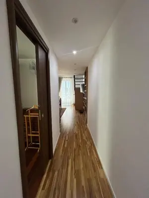 a hallway with a door and a room with wood floors at Appartamento Palermo Sole di Sicilia in Palermo