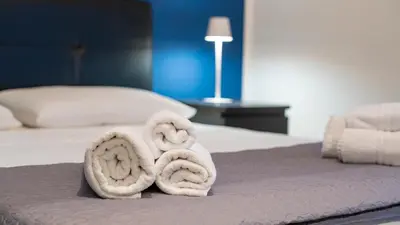a bed with two towels on top of it at La Casetta di Ale - By Rental BeB Italy - in Palermo