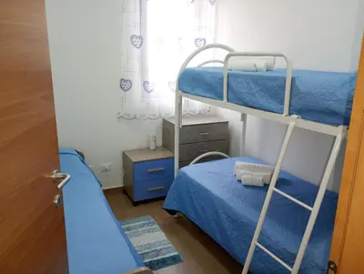 a bedroom with two bunk beds and a window at Casa Agatea in Balestrate