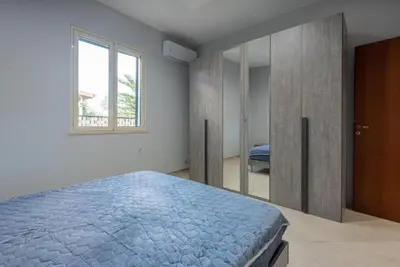 a bedroom with a blue bed and a window at Villino Giovanna a Trabia a 200 mt dal mare in Trabia