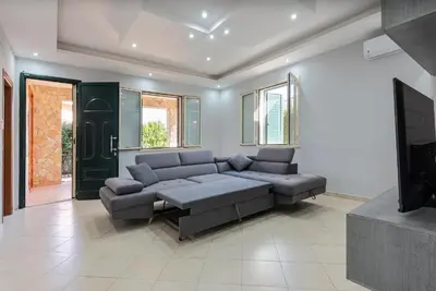 a living room with a couch and a tv at Villino Giovanna a Trabia a 200 mt dal mare in Trabia