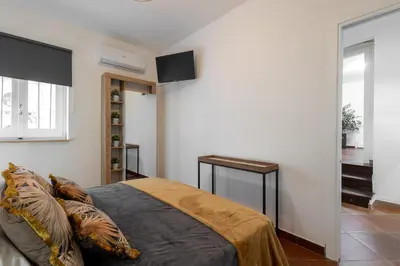 a bedroom with a bed and a desk in it at Maqueda Luxury Suite & Home in Palermo