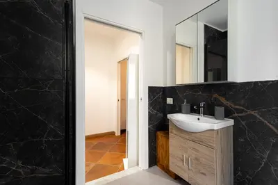 a bathroom with a sink and a mirror at Maqueda Luxury Suite & Home in Palermo