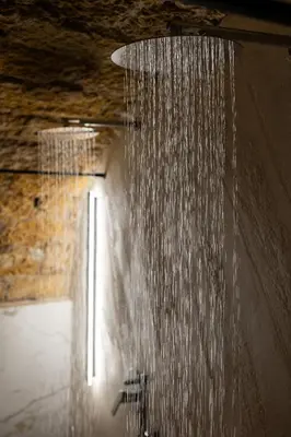 a shower with water hanging from the ceiling at Maqueda Luxury Suite & Home in Palermo