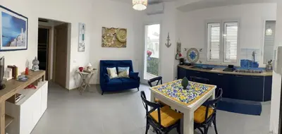 a kitchen and dining room with a table and chairs at Residence Spiaggia Centro - Aria Condizionata Wi-Fi&SelfCheck-In - Sole&Mare Home in Balestrate